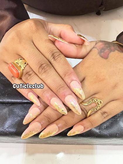 This design features a nude base with a striking gold foil gradient effect, creating a look that is both edgy and glamorous.