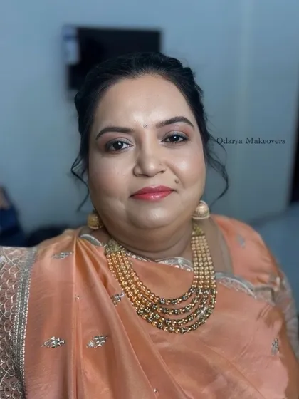 A soft and peachy look for the Sangeet ceremony for the bride's mother. The makeup is fresh and youthful.