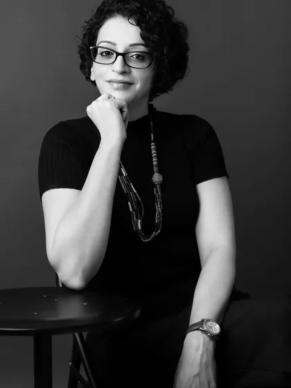 A simple, direct black and white portrait can be incredibly impactful. This headshot captures a moment of quiet confidence and focus, ideal for a professional who wants to convey expertise and trustworthiness.