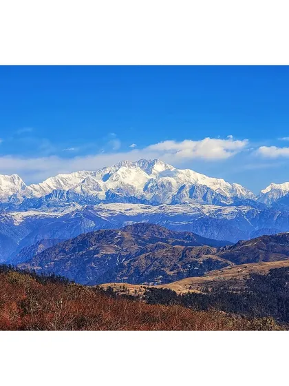 This is the view that makes it all worth it. We're talking about a crystal clear panorama of the Sleeping Buddha range, including the mighty Kanchenjunga, which you can see from the Sandakphu trail.