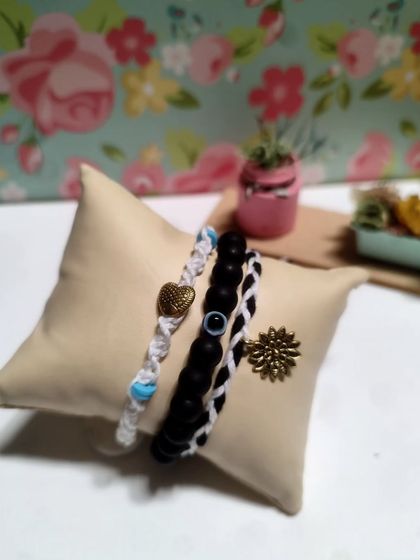 My collection of handmade bracelets, available in many colors and styles. I use beads, evil eye charms, and macrame techniques to create these stackable pieces.