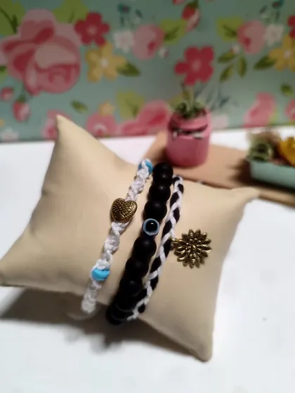 My collection of handmade bracelets, available in many colors and styles. I use beads, evil eye charms, and macrame techniques to create these stackable pieces.