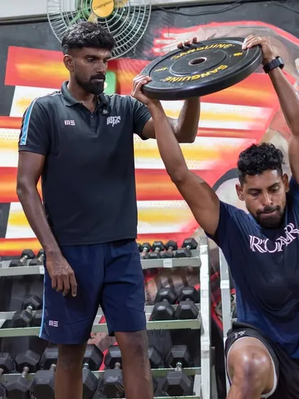 I work closely with elite athletes like Roy Krishna, Fiji's captain and an ISL legend, to ensure they return to sport stronger than before. Here, I am guiding him through a targeted strength exercise, focusing on precise form to build power and prevent re-injury. This level of personalized coaching is central to my approach for every athlete.