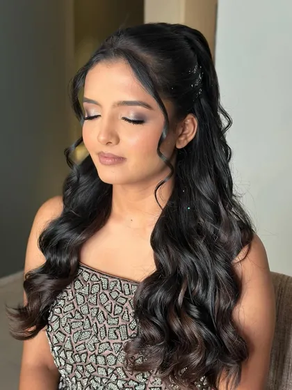 Our Poo got the glam and drama just right. This look features a classic smokey eye, sculpted cheeks, and a neutral lip, perfect for a high-energy reception or cocktail party.