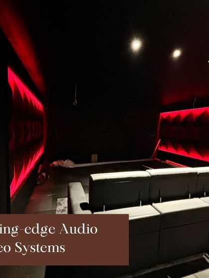 A glimpse of a cutting-edge audio-video system under construction at our Jive showroom. The red ambient lighting and acoustic panels are part of creating a truly immersive theater experience.