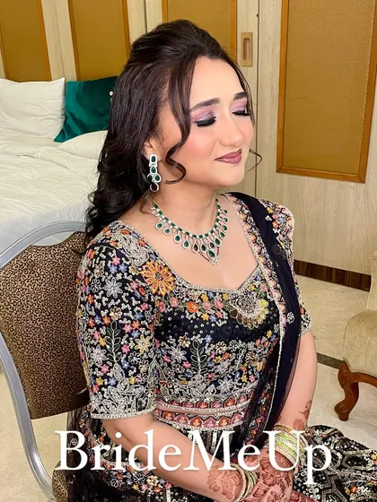 A beautiful reception look for my bride Amita. The half-up hairstyle with soft curls is adorned with a delicate accessory, complementing her embroidered lehenga.