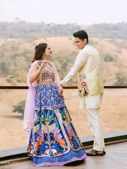 The couple shares a look of love against the backdrop of the Nashik hills, a beautiful portrait from their carnival wedding.