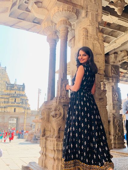 A happy traveler posing at the Virupaksha Temple.