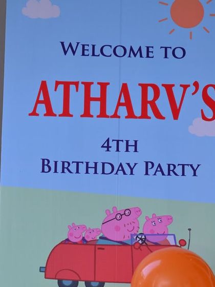The welcome sign for Atharv's 4th birthday, featuring the Peppa Pig family in their red car.