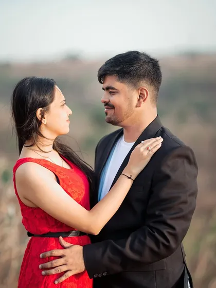 A sweet, romantic gaze between a couple during their outdoor pre-wedding shoot in a natural, rustic setting.
