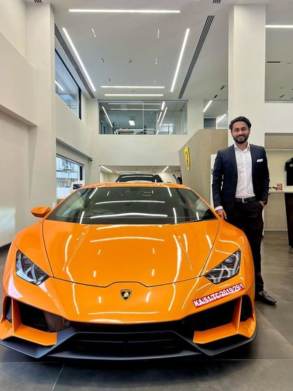 Pictured with a vibrant orange Lamborghini Huracán at the Bengaluru showroom. I am deeply integrated into the luxury automotive scene, both professionally and personally.