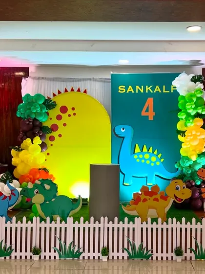 The Dinosaur theme setup under party lighting, creating a fun and exciting atmosphere for a 4th birthday.