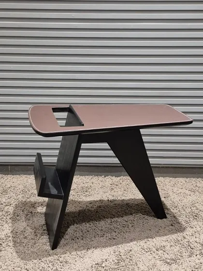 A very modern, angular side table with a built-in magazine holder. A perfect example of functional design.