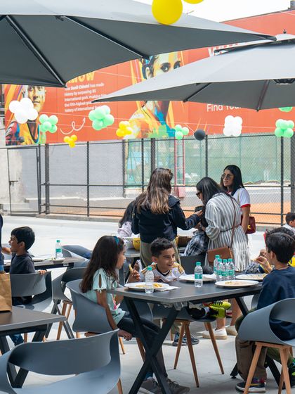 Guests enjoying the outdoor seating and food at the football-themed celebration.