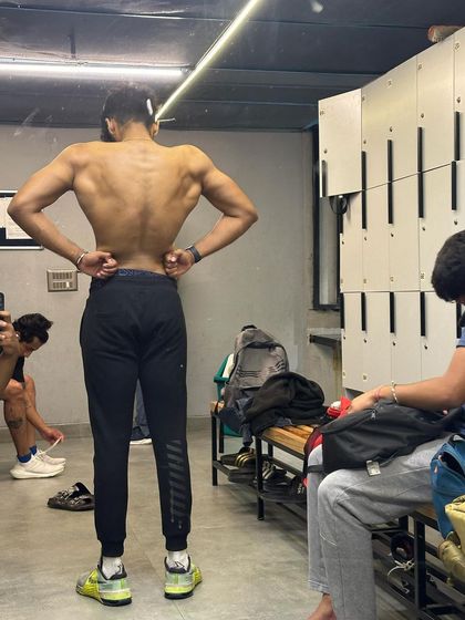 Tracking the V-taper. The lighting and mirrors in our locker room are perfect for checking your form and seeing your physique take shape.