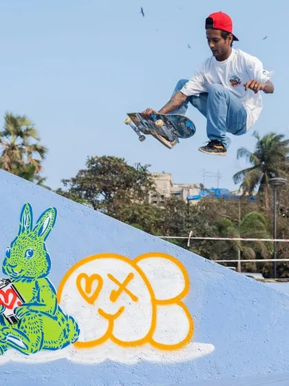 A skater catches air next to a character piece by one of the collaborating artists. The goal was to create art that interacts with the movement of the park.