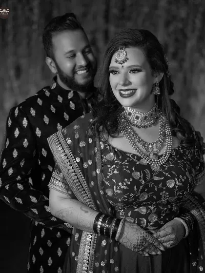 Black and white photography offers a timeless, classic feel. This candid shot from a reception shows the joy and connection between the couple, focusing purely on the emotion of the moment.