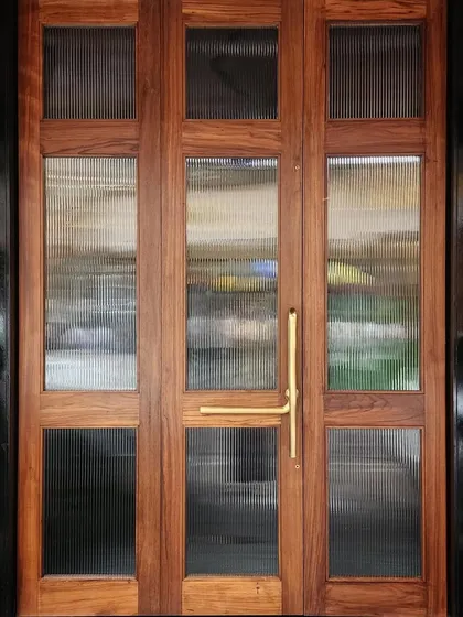 The bespoke teak wood and fluted glass door we designed for Americano restaurant in Mumbai. The warm wood and brass handle create a welcoming entrance that feels both classic and contemporary.