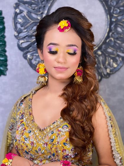 A close-up of the colourful Haldi eye makeup, featuring a blend of yellow and purple eyeshadow to match the client's outfit.