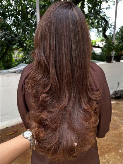 A beautiful color refresh for this client, getting her vacay-ready. I added soft, natural-looking highlights to her long hair and finished with a layered cut and bouncy curls for a glamorous feel.