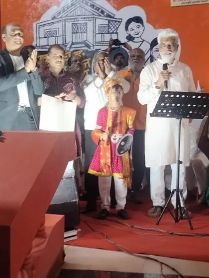On stage with Hon. Shri Dadaji Bhuse during a felicitation ceremony.