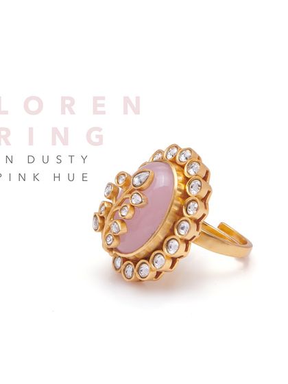 The Loren Ring in a dusty pink hue showcases a beautiful center stone embellished with Mughal-inspired artistry. It's an adjustable ring that adds a touch of vintage charm.