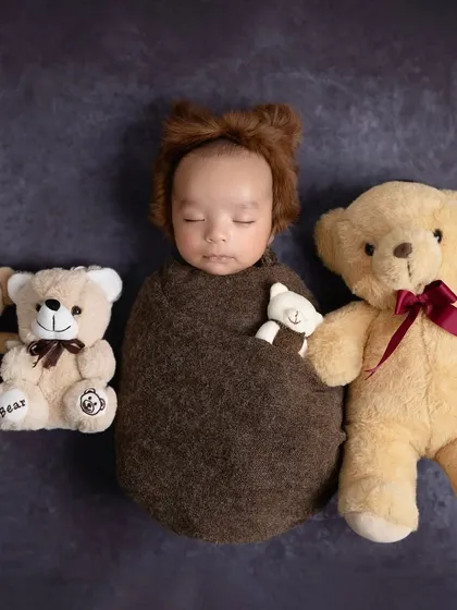 Sometimes the simplest theme is the sweetest. A baby bear nestled amongst his teddy bear friends, looking so cozy and content.