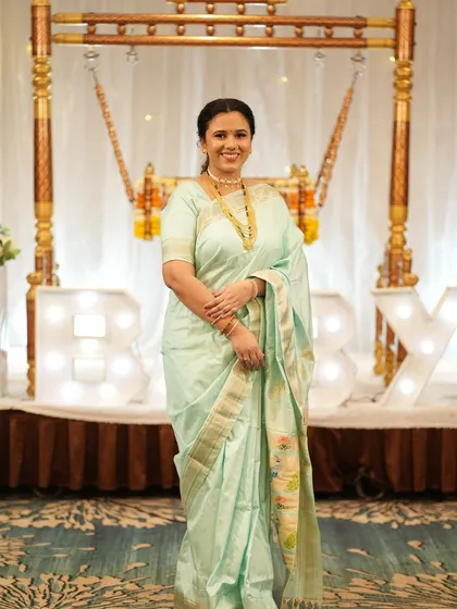 A full-length view of her beautiful pastel saree and traditional jewelry for the naming ceremony, all brought together with my makeup and draping service.