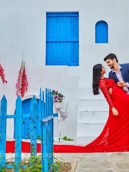 The vibrant contrast of a red gown against the blue and white of our Santorini set makes for a visually stunning and romantic pre-wedding photograph.