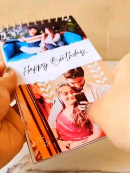 Flipping through the pages of a mini birthday album, showing how each page can feature a different photo and memory.