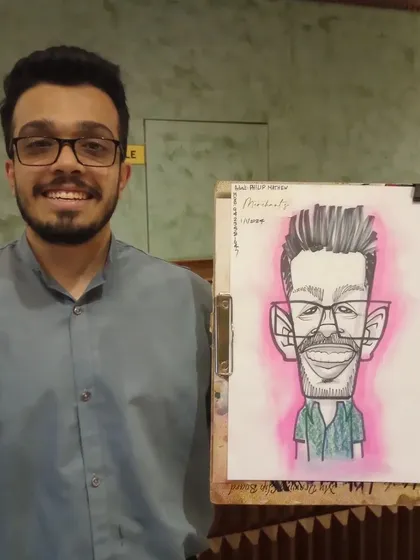 A happy guest with his caricature, which has a nice pink glow.