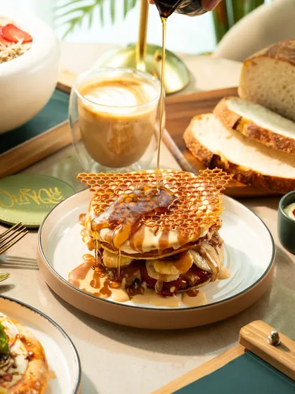 A close-up of the honey pour, highlighting the gooey texture and fresh ingredients.