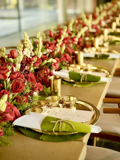 Elegance is in the details. A beautifully arranged tablescape for a pre-wedding celebration, featuring our bespoke, all-Jain thaali served in traditional brassware. We believe the presentation is just as important as the meal itself.