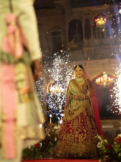 The bride's joyful entrance, walking towards the mandap with a backdrop of sparkling lights. We design bridal entries that are filled with anticipation and personal significance.
