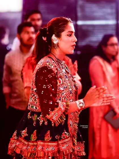 A candid shot of a dancer clapping to the rhythm, her focus entirely on the music and the celebration.