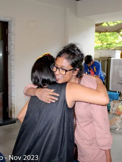 The power of community. Two of our volunteers share a hug at an adoption camp, celebrating a day of successful adoptions and teamwork.