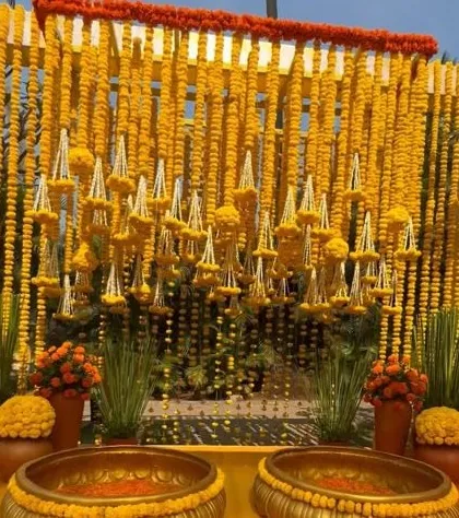 We love bringing the vibrant energy of a Haldi ceremony to life. This setup features a dense wall of fresh marigolds (genda) and traditional brass urlis, creating a picture perfect, sun-kissed setting for your pre-wedding festivities.