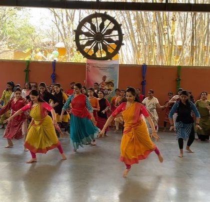 The vibrant energy of dancers learning together in an open, natural setting at the Shankara Foundation for the Dance Jatre festival.