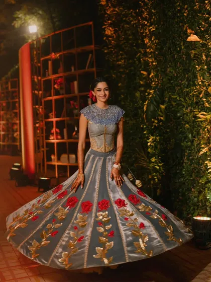 The bride's twirling lehenga is a classic wedding shot, made unique by the whimsical library-themed backdrop.