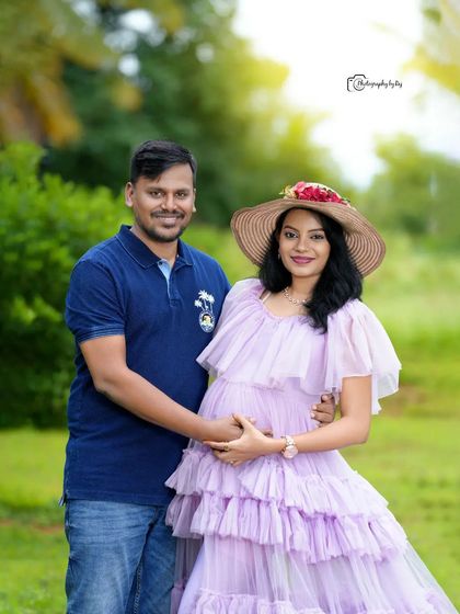 A romantic couple's portrait in a lavender ruffled gown. The hat and the beautiful trees create a perfect outdoor scene.