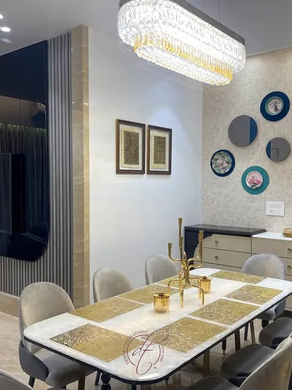 This view shows the dining area's wall decor, featuring a collection of circular mirrors and art plates. The design adds a personal and artistic touch to the space, making it feel unique and curated.