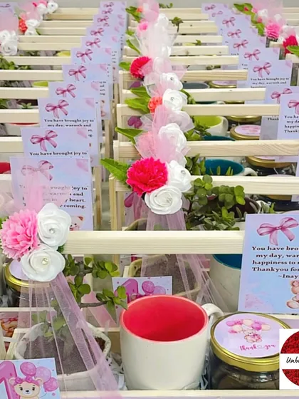 A close-up of the teddy bear favors, highlighting the colorful mugs and personalized cards.
