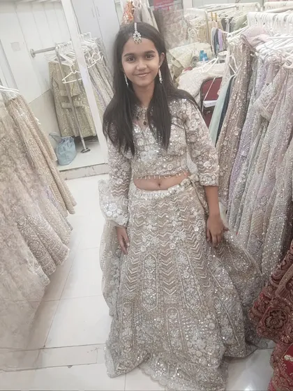 A slightly different angle of the young client in the lehenga, showing the details of the skirt.