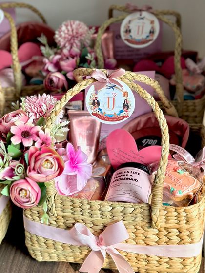 Another angle of the beautiful pink-themed bridesmaid baskets. The custom tag with the couple's initials adds such a wonderful personal touch to the whole gift.