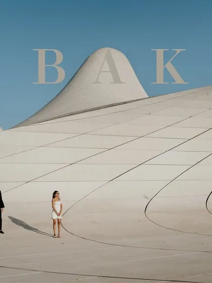 We used the stunning, futuristic architecture of the Heydar Aliyev Center in Baku, Azerbaijan, as a canvas. This minimalist composition highlights the couple against the building's clean lines, creating a modern and artistic pre-wedding photograph.
