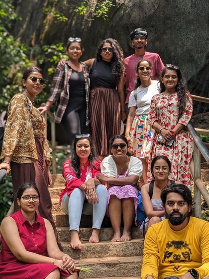 A group of friends posing on the steps of a temple during our Gokarna trip.