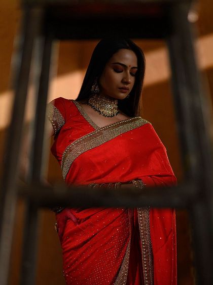 A creative composition using a ladder to frame the subject. The play of light and shadow adds depth and drama to this portrait.