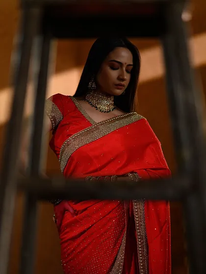 Using a ladder to frame the subject, this shot from the 'Rang Lageya' series has an almost voyeuristic feel. The play of light and shadow adds to the contemplative mood.