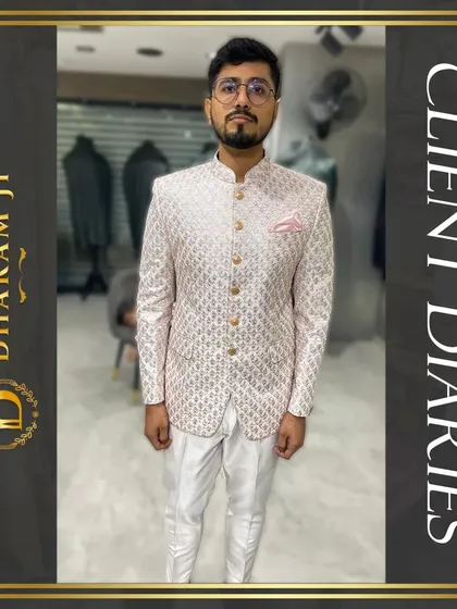 A happy client trying on his custom-made pink and white patterned Bandhgala. The perfect fit and unique design made him ready for his special event right from the final trial.
