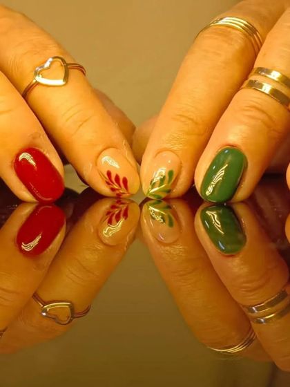 A close-up of the beautiful hand-painted holly nail art.